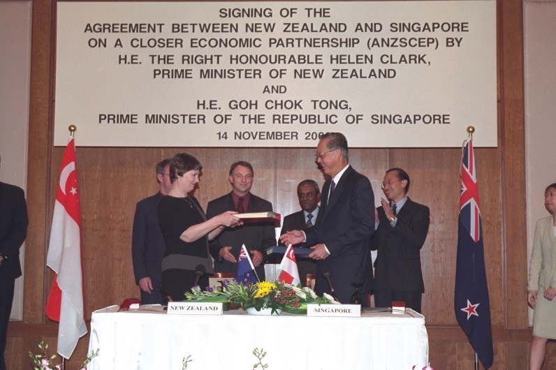 An image of the signatories of the CEP shaking hands at a ceremony. . 