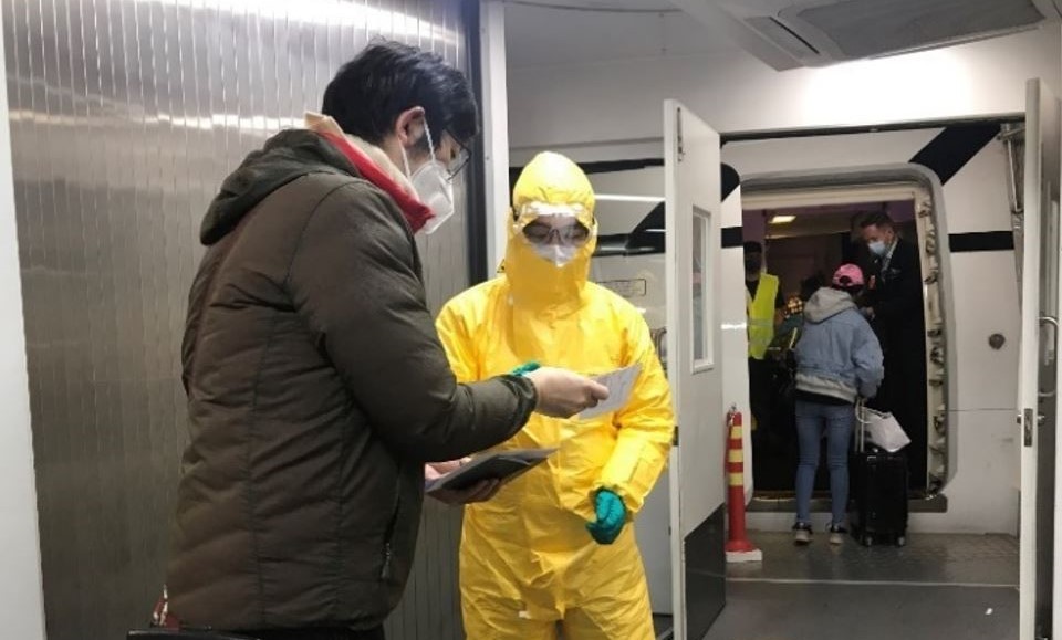 An image of MFAT and Air NZ staff assisting New Zealanders boarding the flight from Wuhan to Auckland.. 