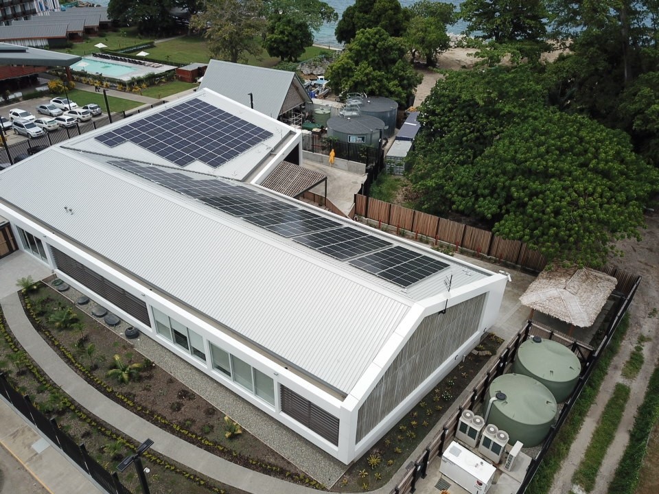 An image of a building with solar panels on the roof. 