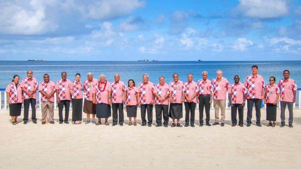 An image of members of the Pacific Islands Forum. posing for a photo on the beach. . 