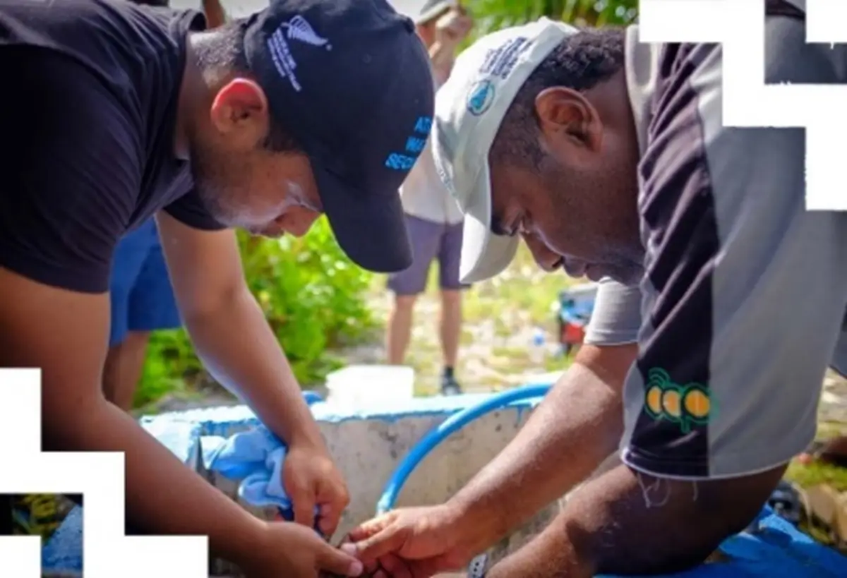 An image of two men working together. 