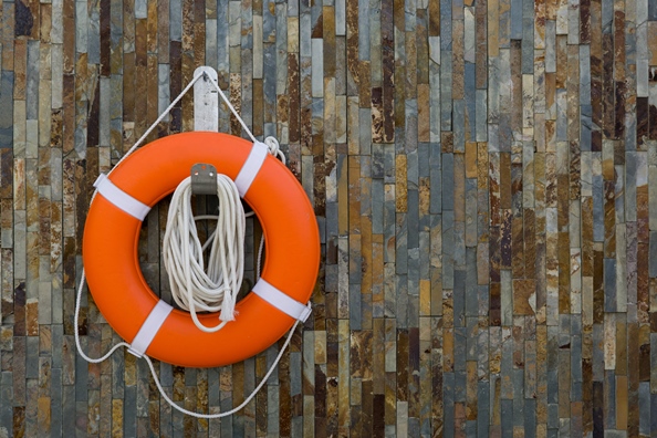 Orange life ring hanging on a wall. 