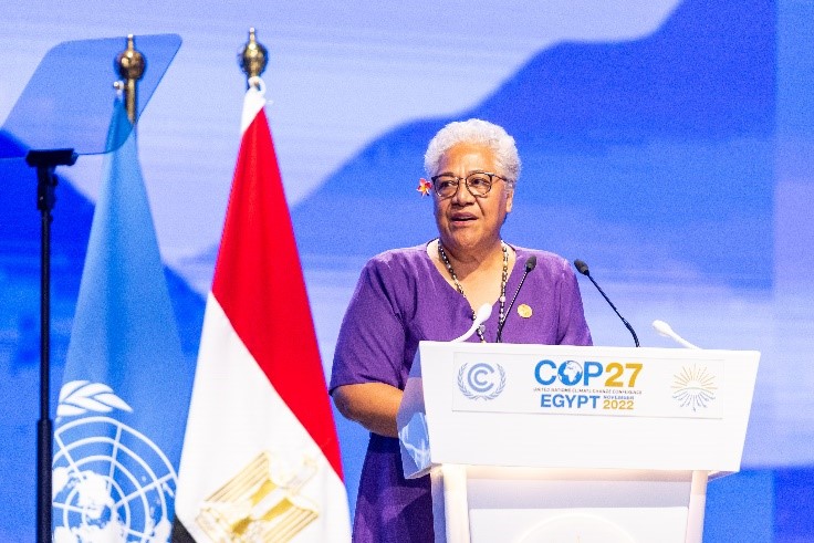An image of Samoa’s Prime Minister, Afioga Fiame Naomi Mataafa, standing at a podium addressing an unseen audience. . 