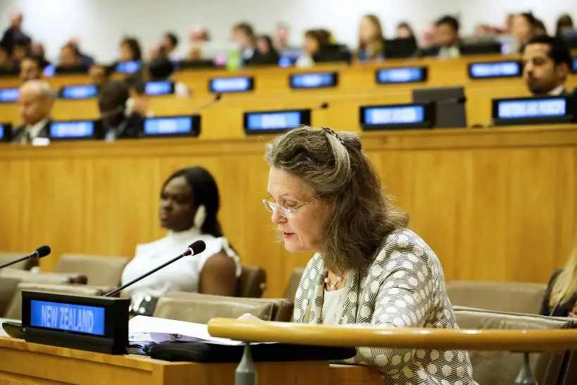An image of a female NZ representative speaking at a conference. . 