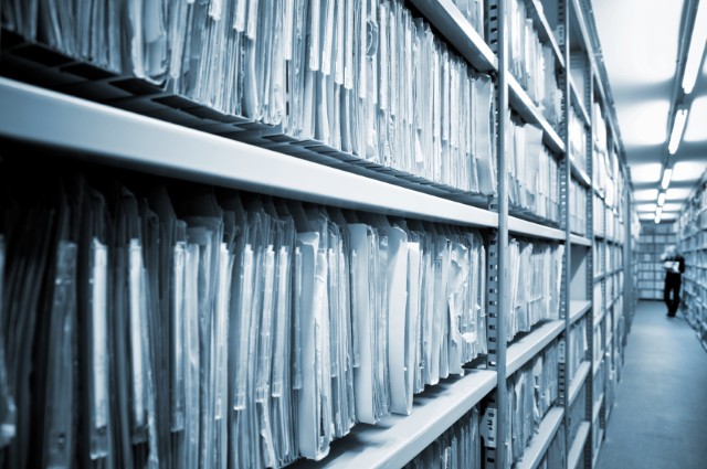 Documents on a library shelf. 