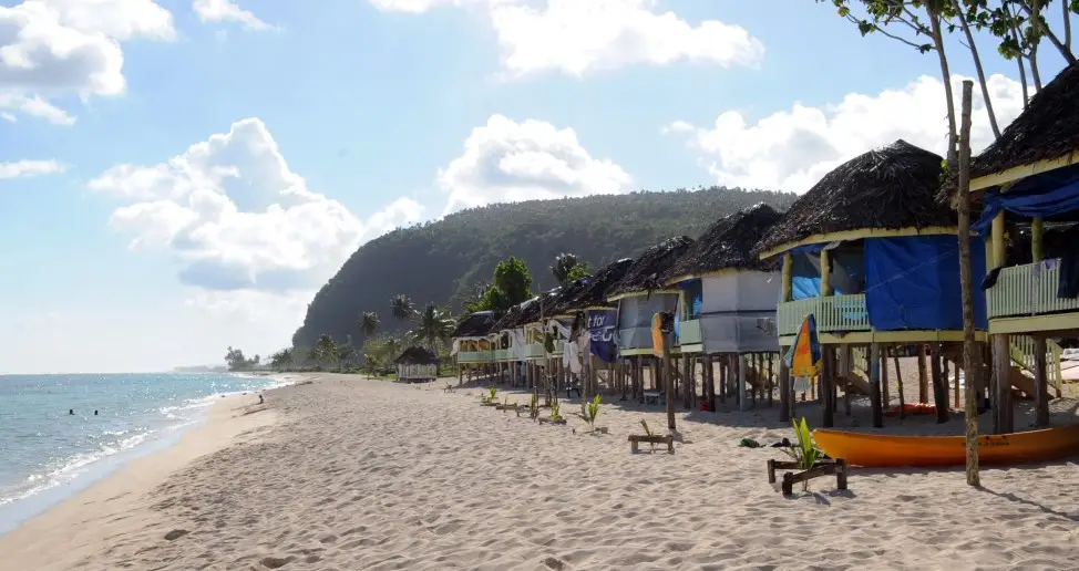 A row of fale on a beach.