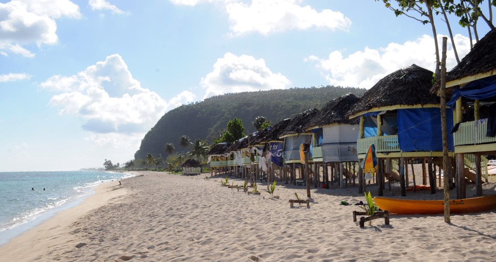 A row of fale on a beach. 