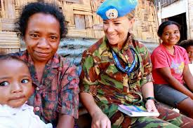 An image of an NZDF troop sitting with locals. .